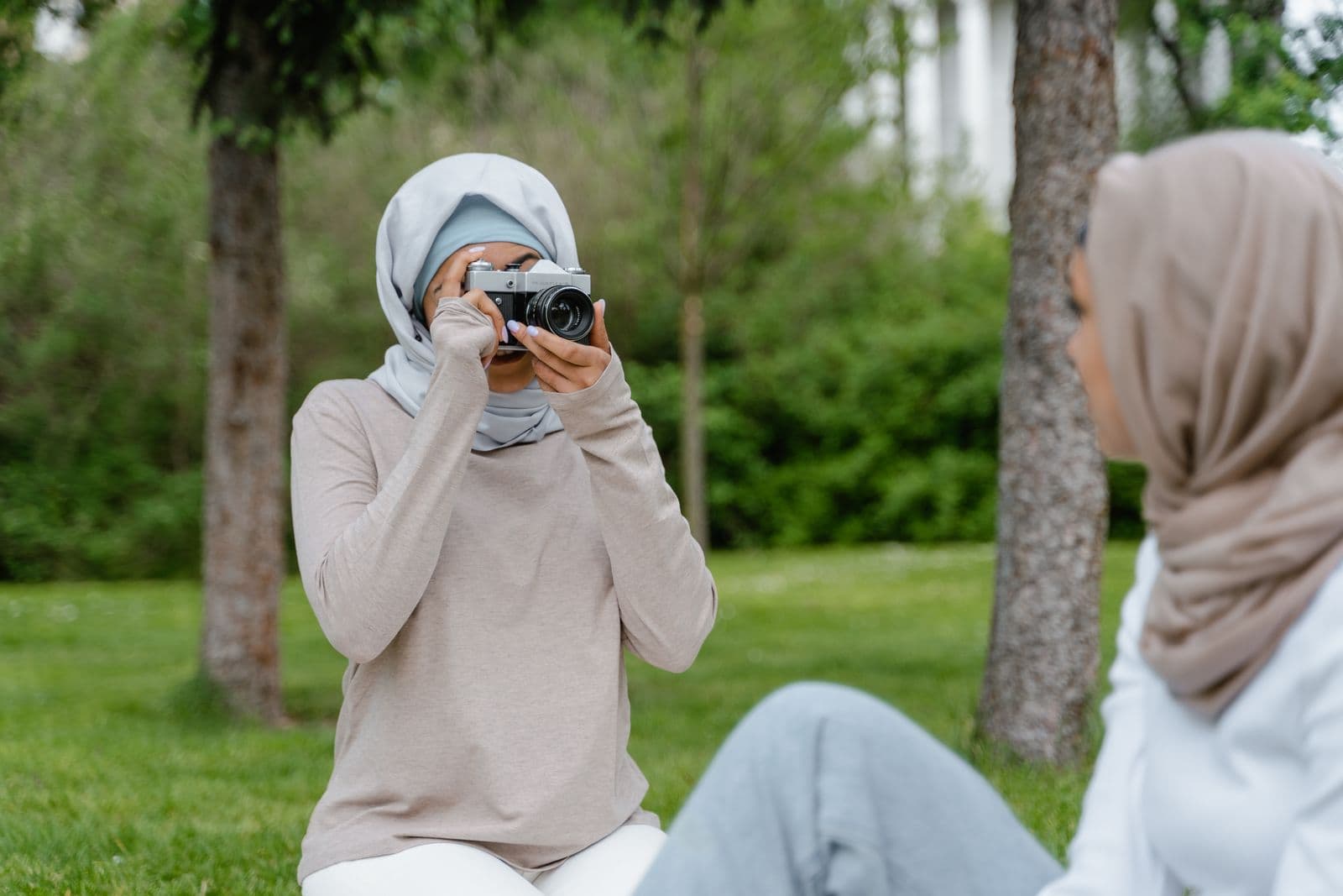 Friends taking photographs outdoors; illustrative stock photography