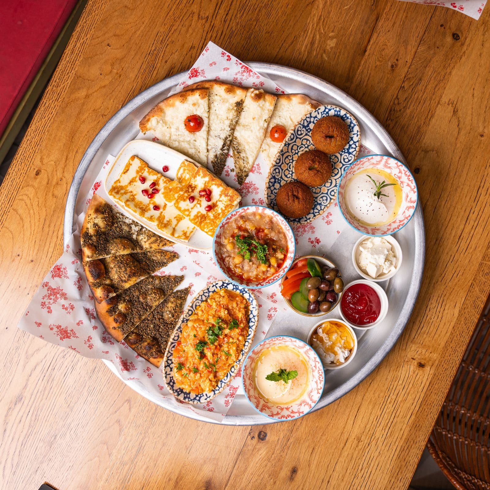A colourful spread of breads, dips and mezze; illustrative stock photography