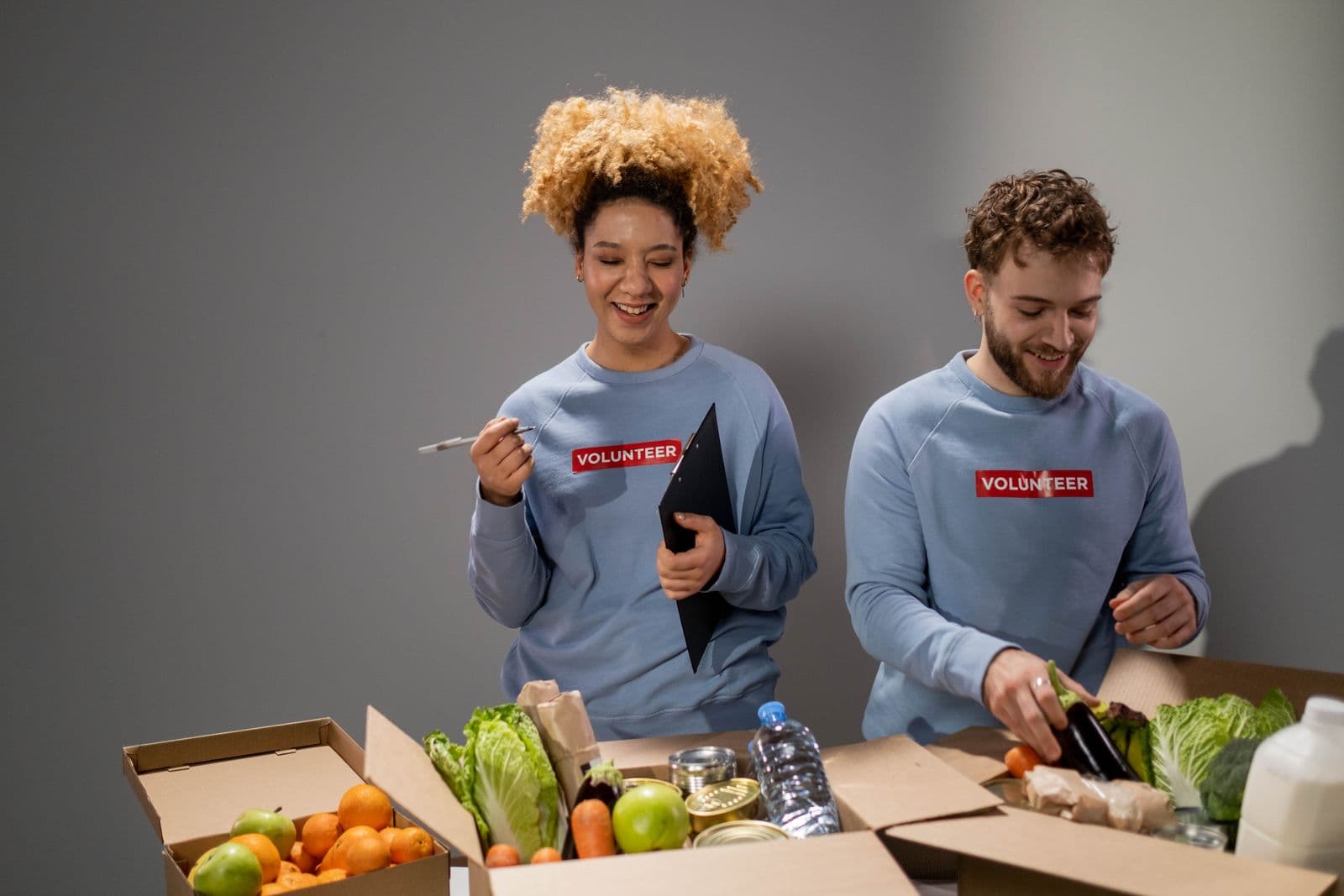 Volunteers packing donation boxes; illustrative stock photography